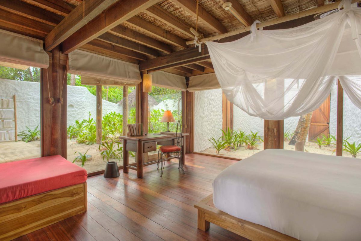 Master Bedroom inspired by nature: raw wood that retains its gnarls and bends, woven ropes, recycled planks and palm thatch